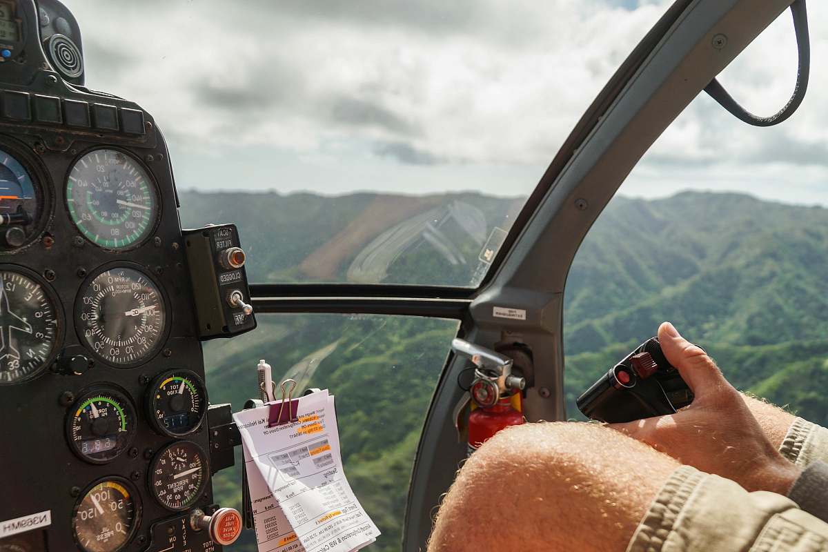hawaii person driving helicopter from above cockpit